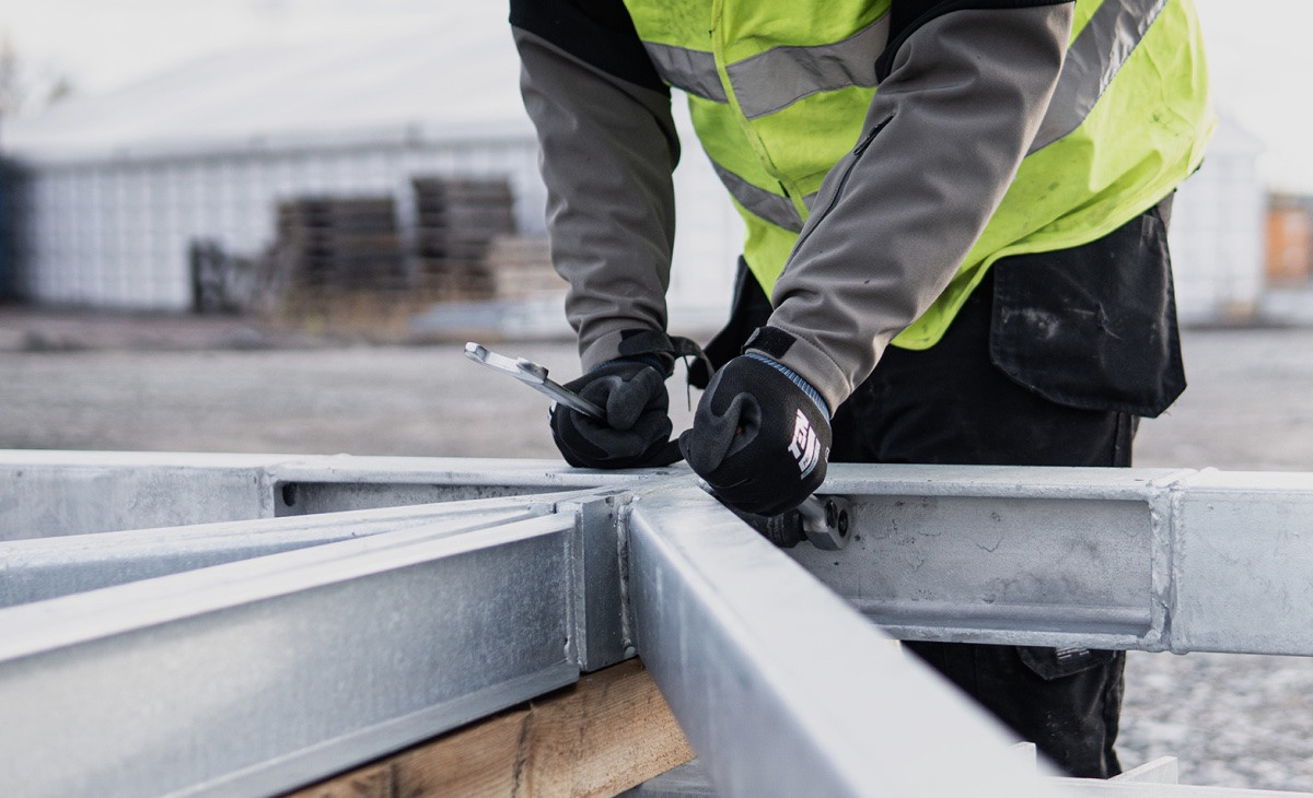 Worker adjusting a cold-formed-steel truss.